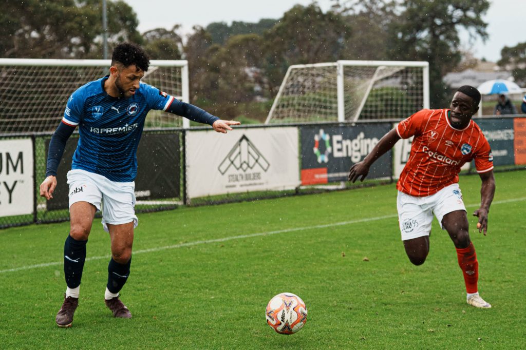 Semi-professional footballers contesting the ball, Langwarrin